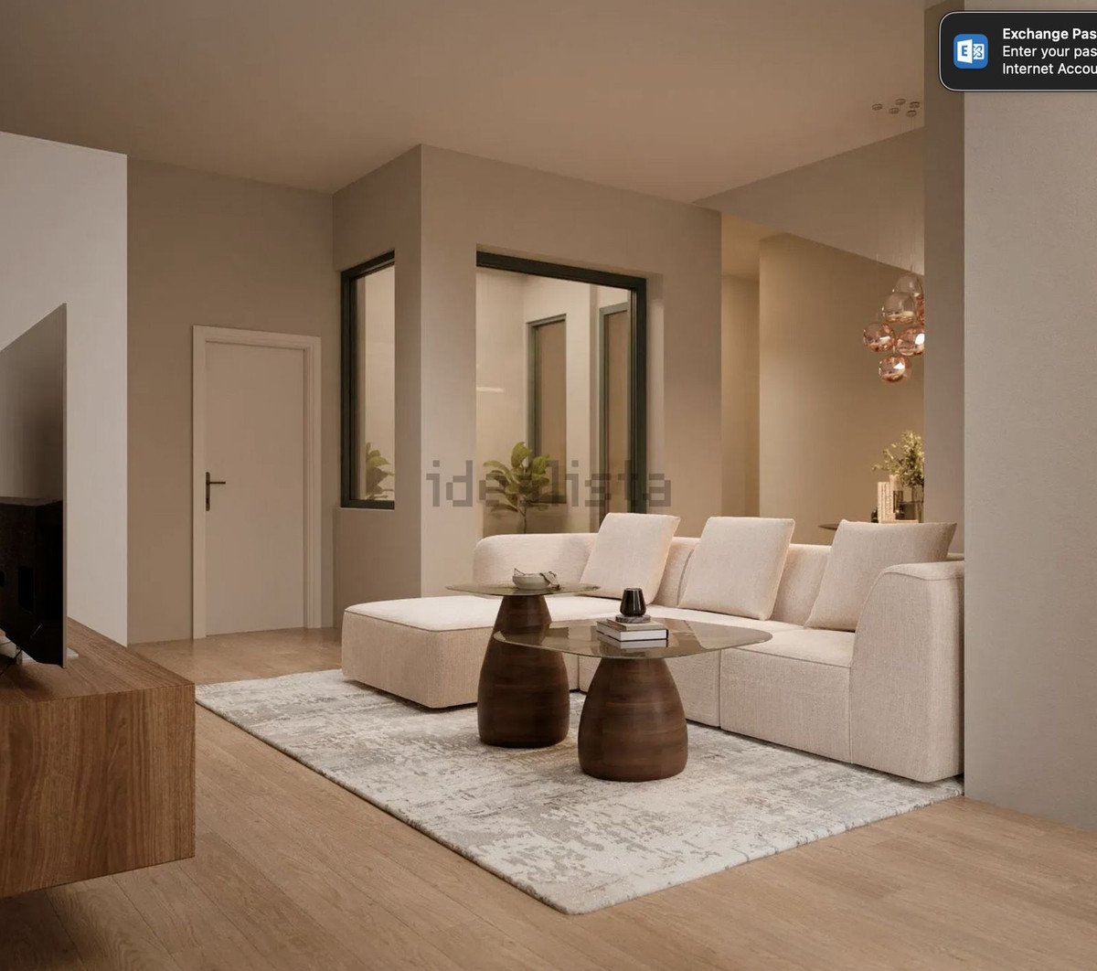 Modern living room with beige furniture, large windows, and a cozy rug.