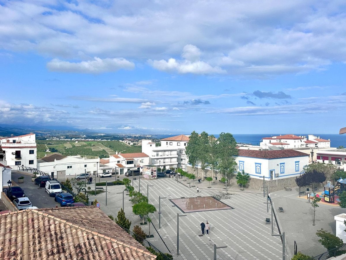 Town square with ocean view and surrounding buildings