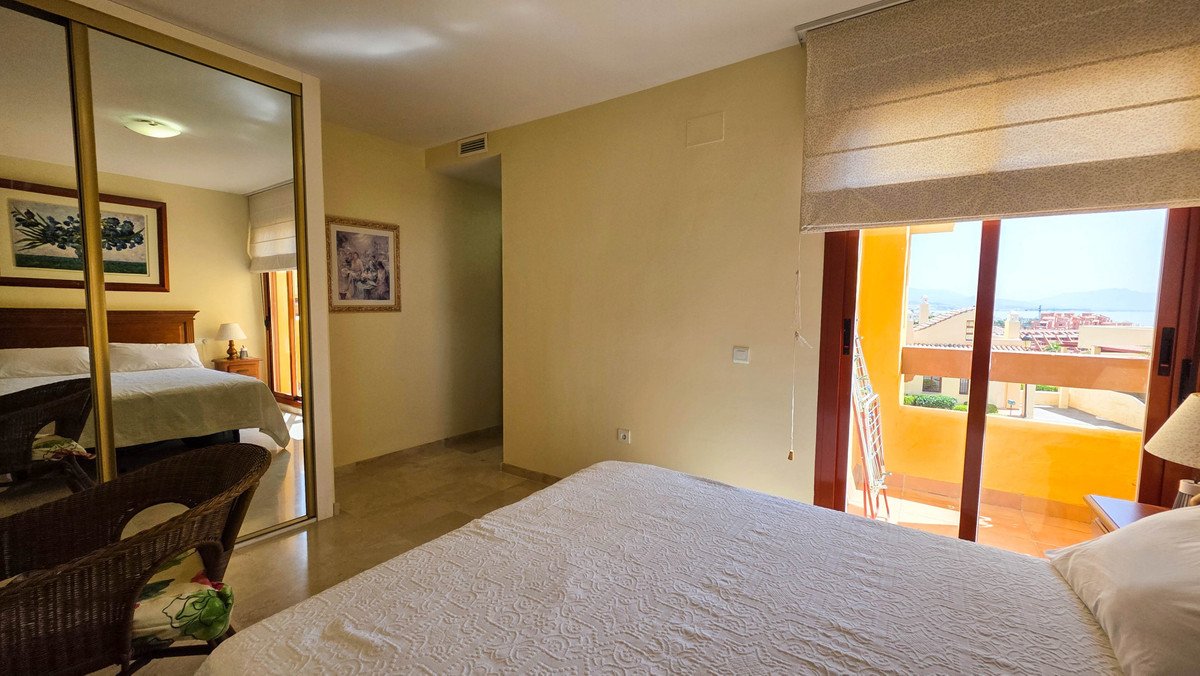 Bedroom with twin beds, large window, and balcony view