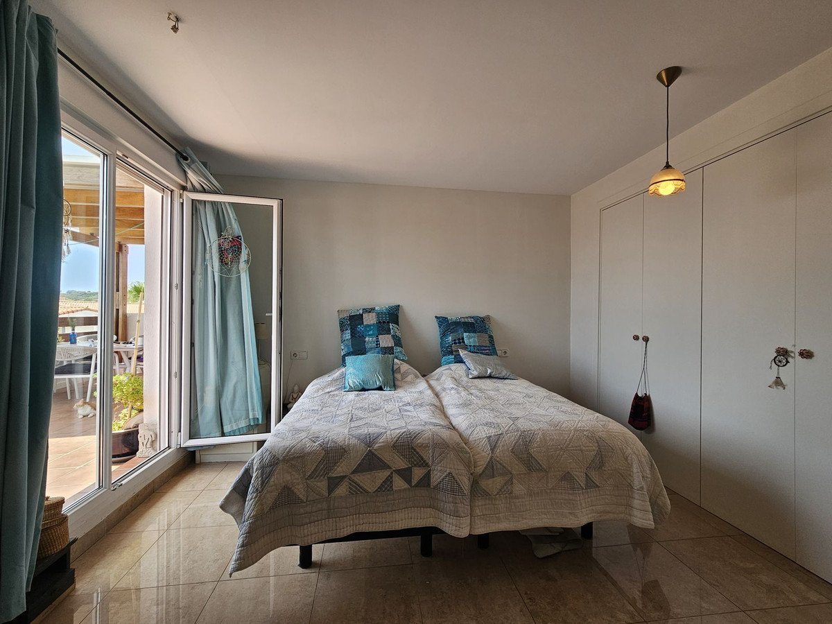 Bedroom with twin beds, sea view, and sliding glass doors