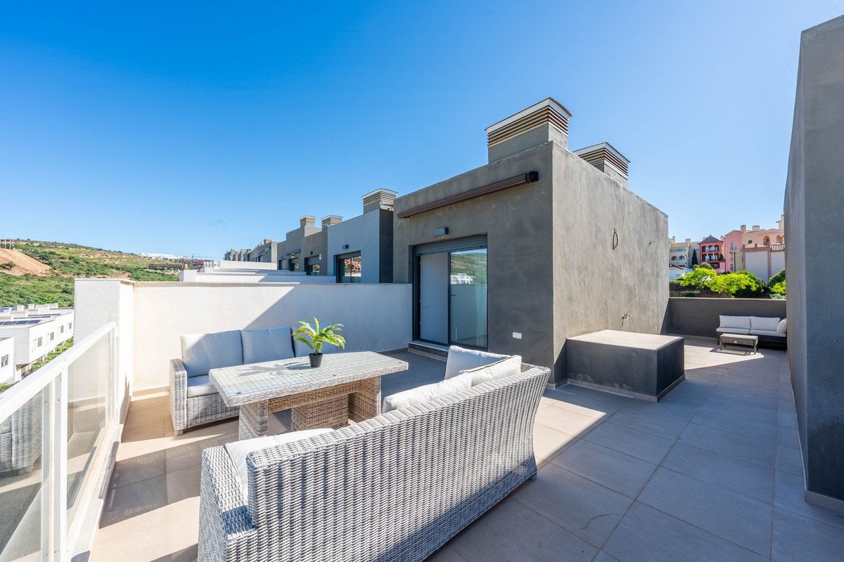Modern outdoor lounge with wicker furniture and sea view