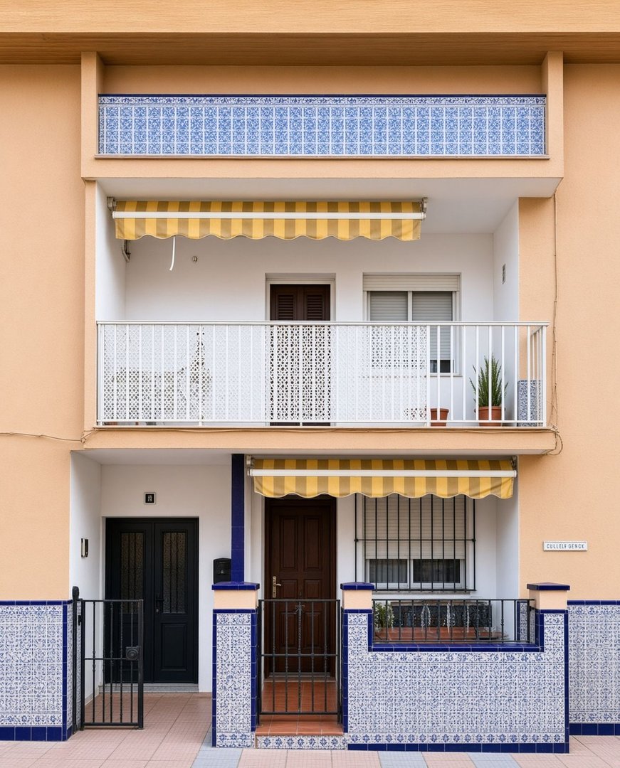 Two-story facade with balconies, awnings, decorative tiles, and two front doors with gates.