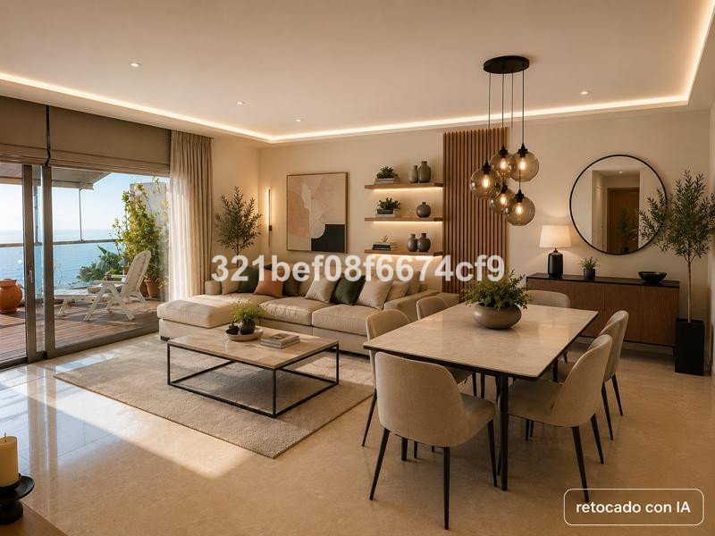 Modern living and dining area with a sectional sofa, dining table, and balcony access overlooking the sea.