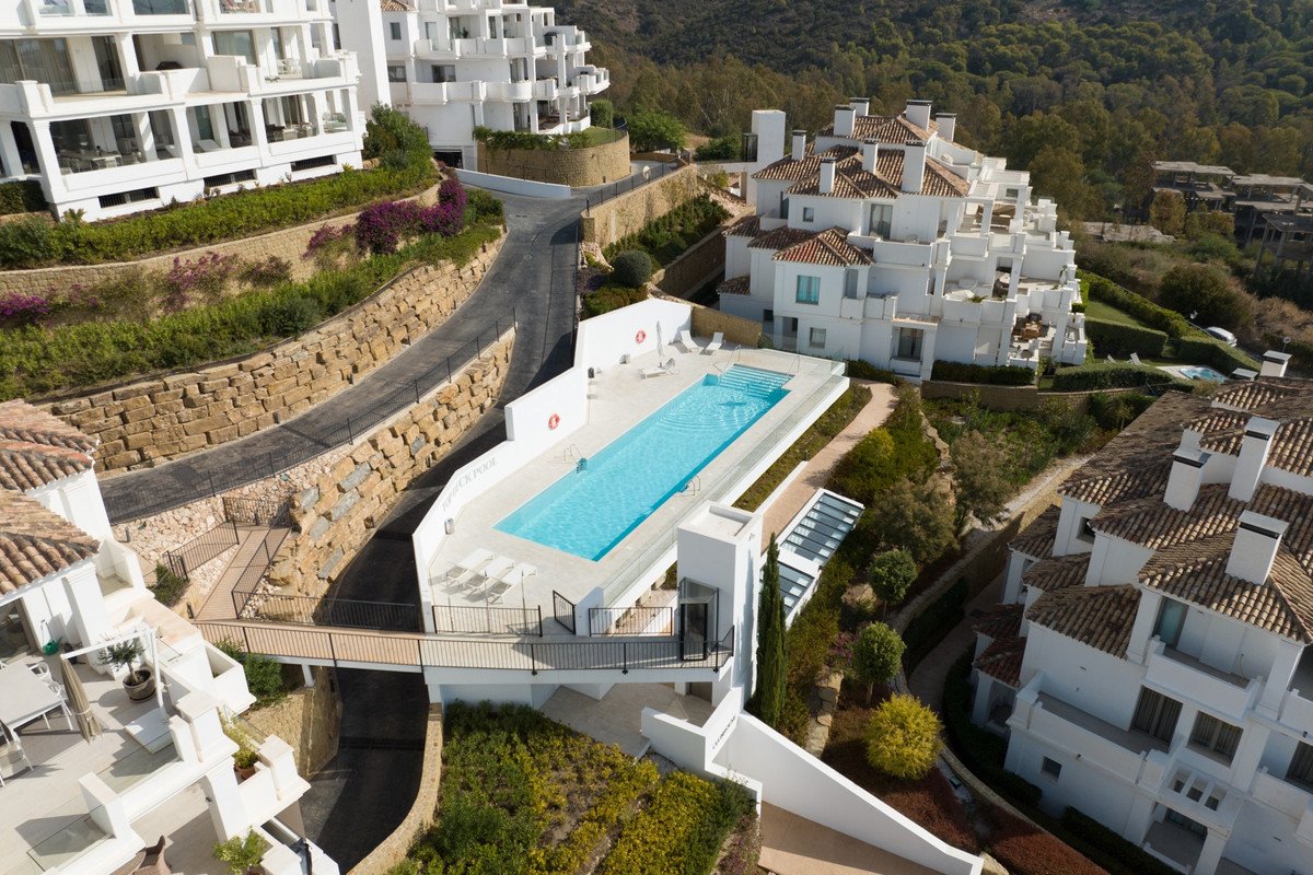 Luxurious white villa with swimming pool overlooking green hills
