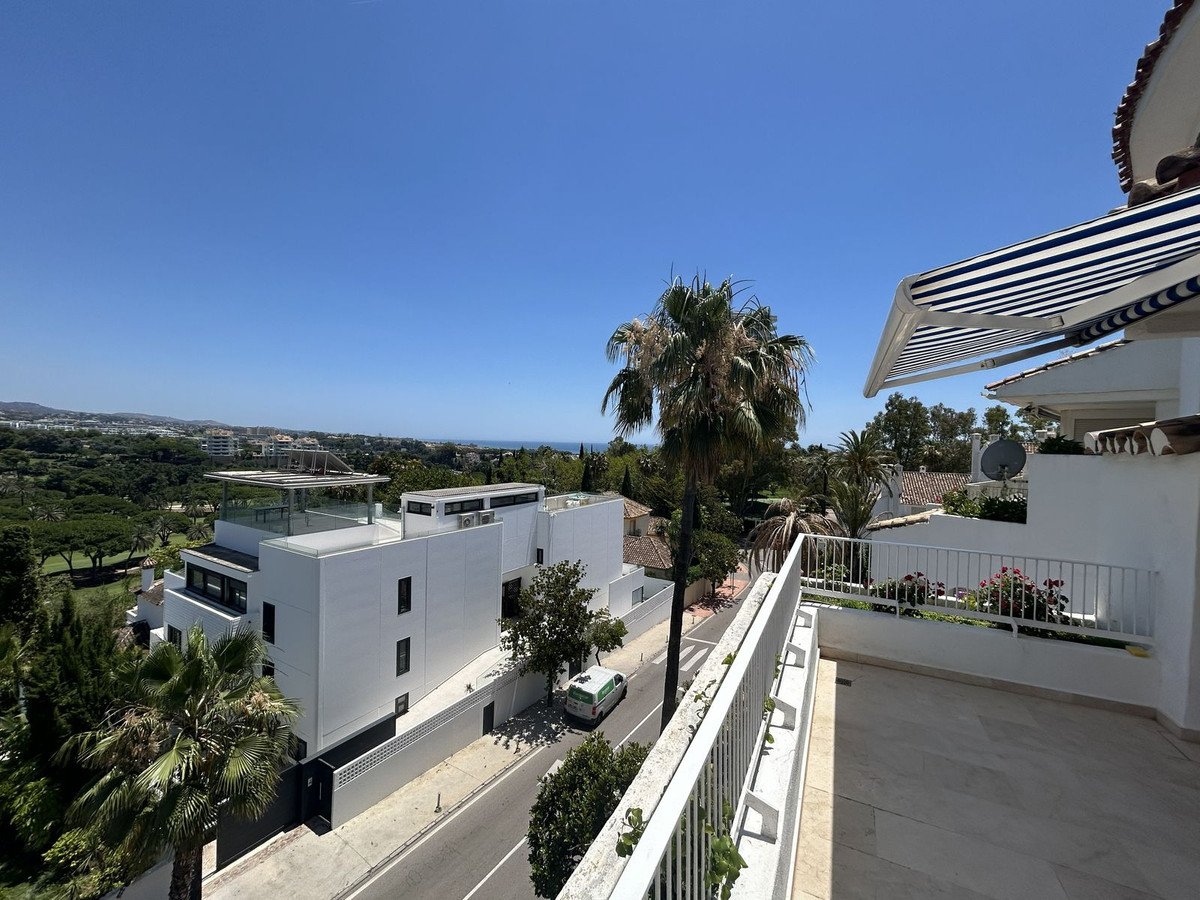 Balcony with palm tree and scenic view of the sea and surrounding landscape