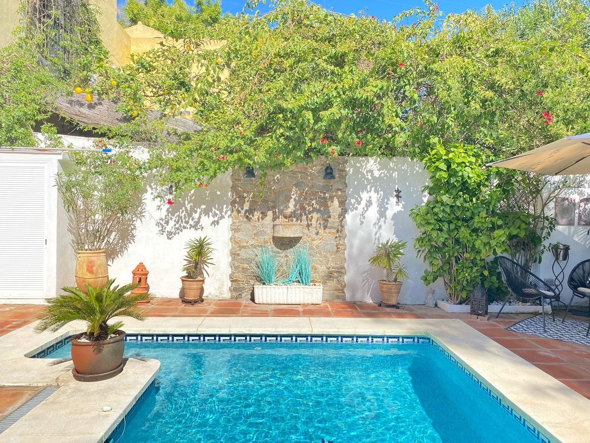 Swimming pool with tropical garden and stone wall backdrop