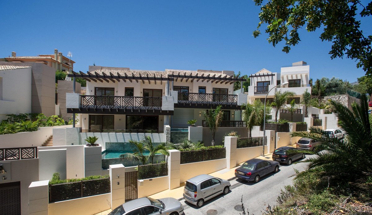 Modern two-story house with swimming pool and parked cars