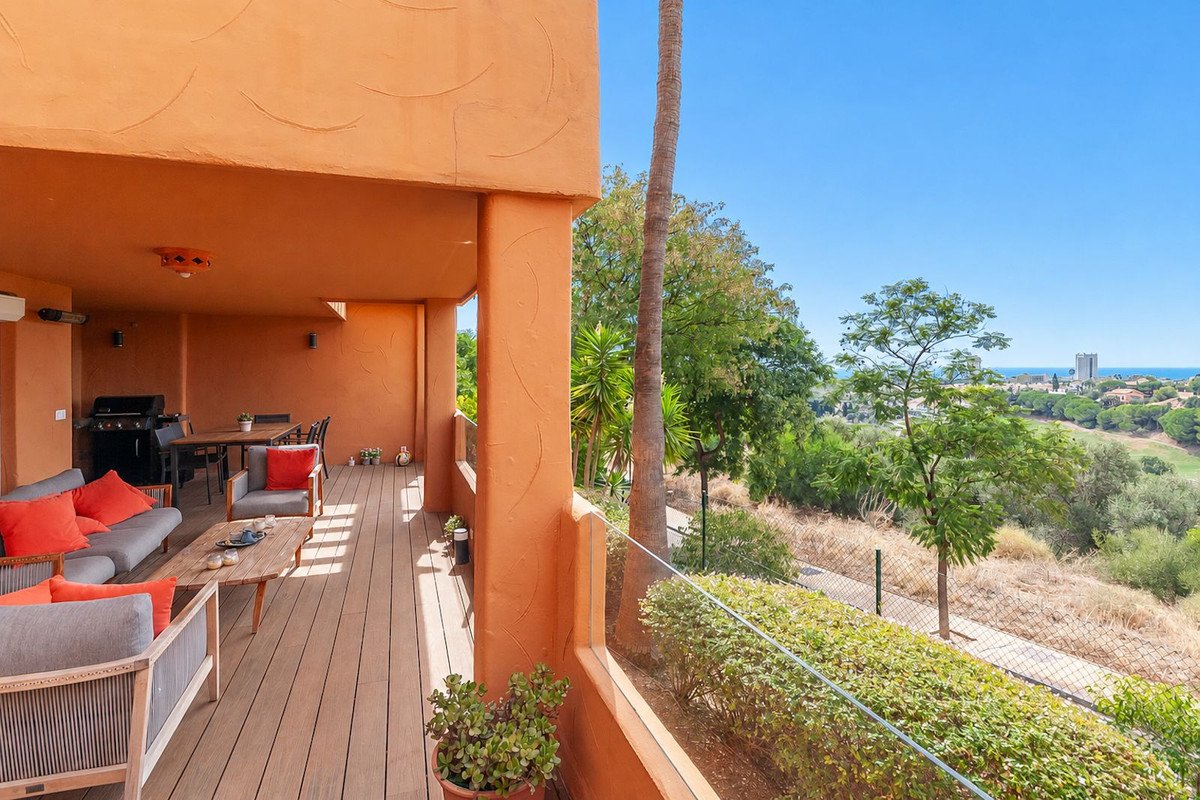 Spacious terrace with seating, dining area, barbecue, and scenic golf course view.