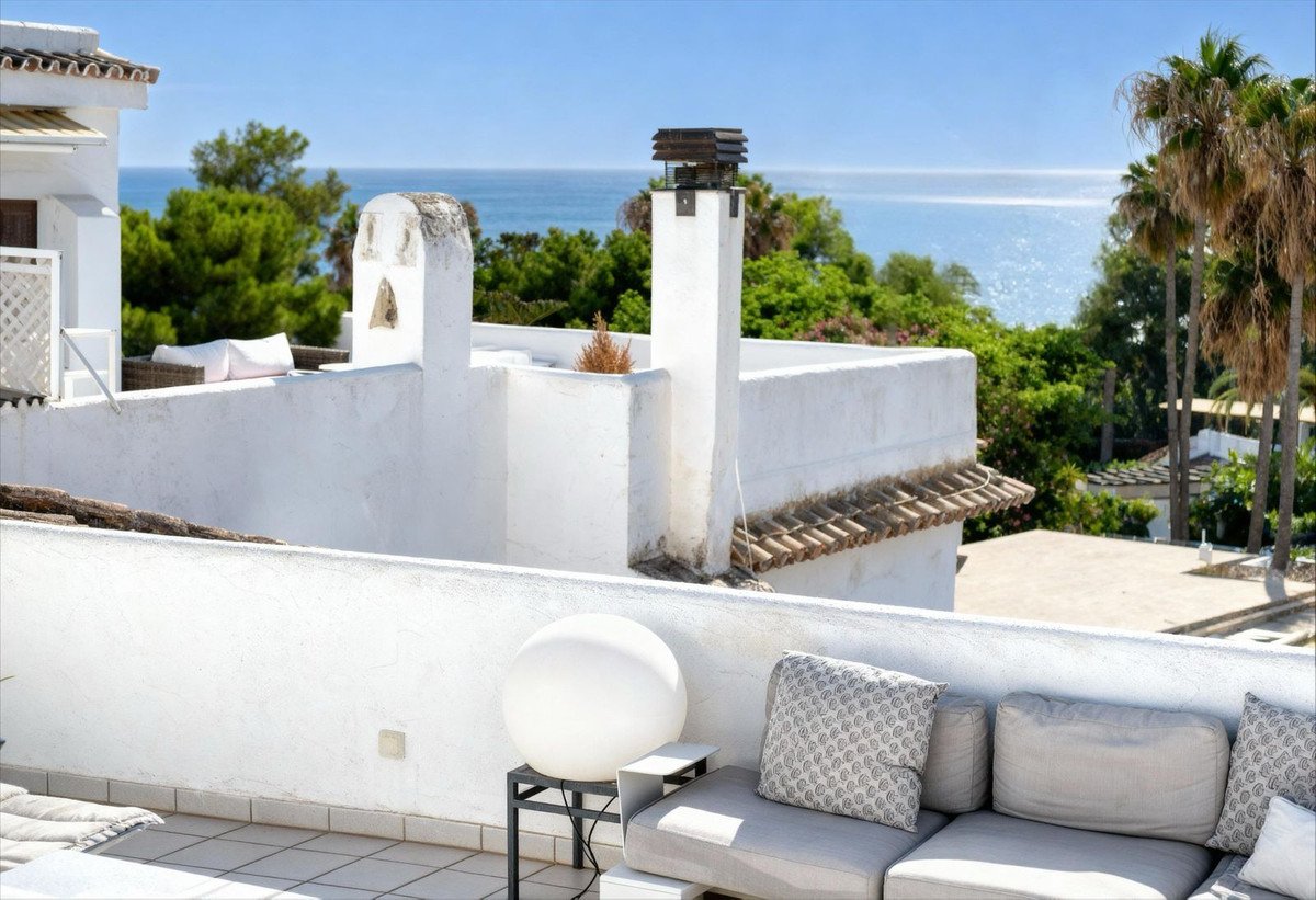 Rooftop terrace with lounge seating and ocean view