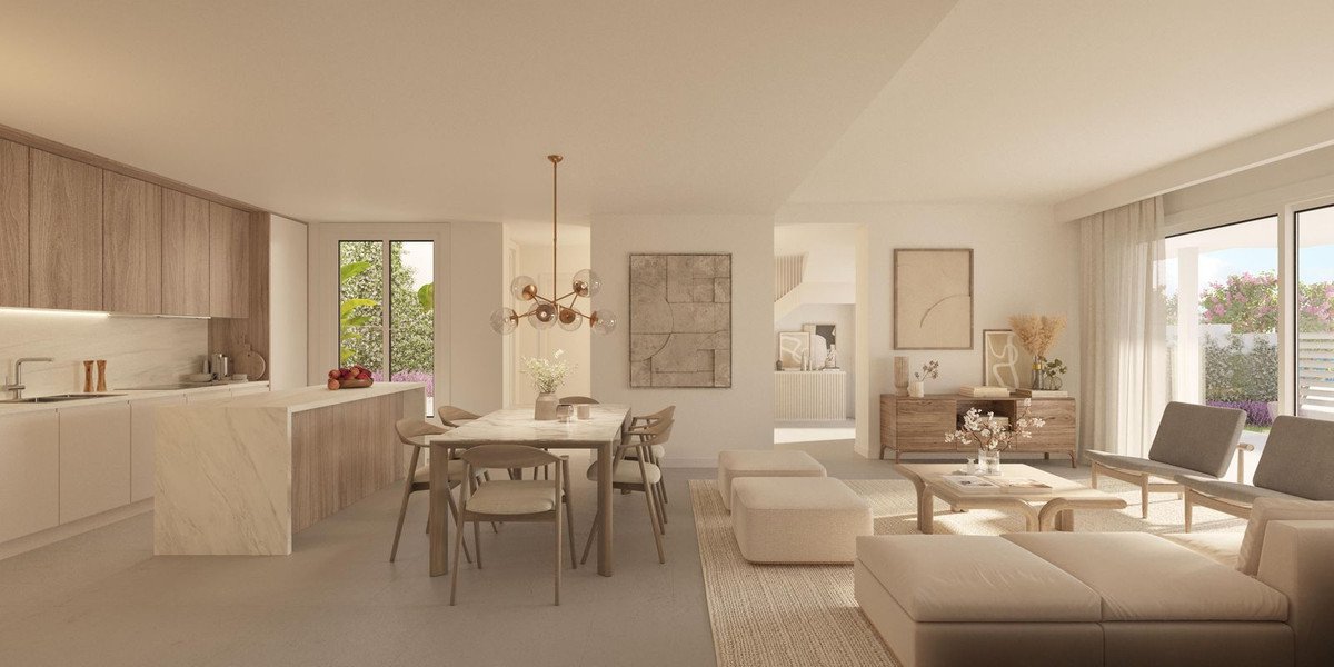 Spacious open-plan living, dining, and kitchen area with modern furniture and garden view.