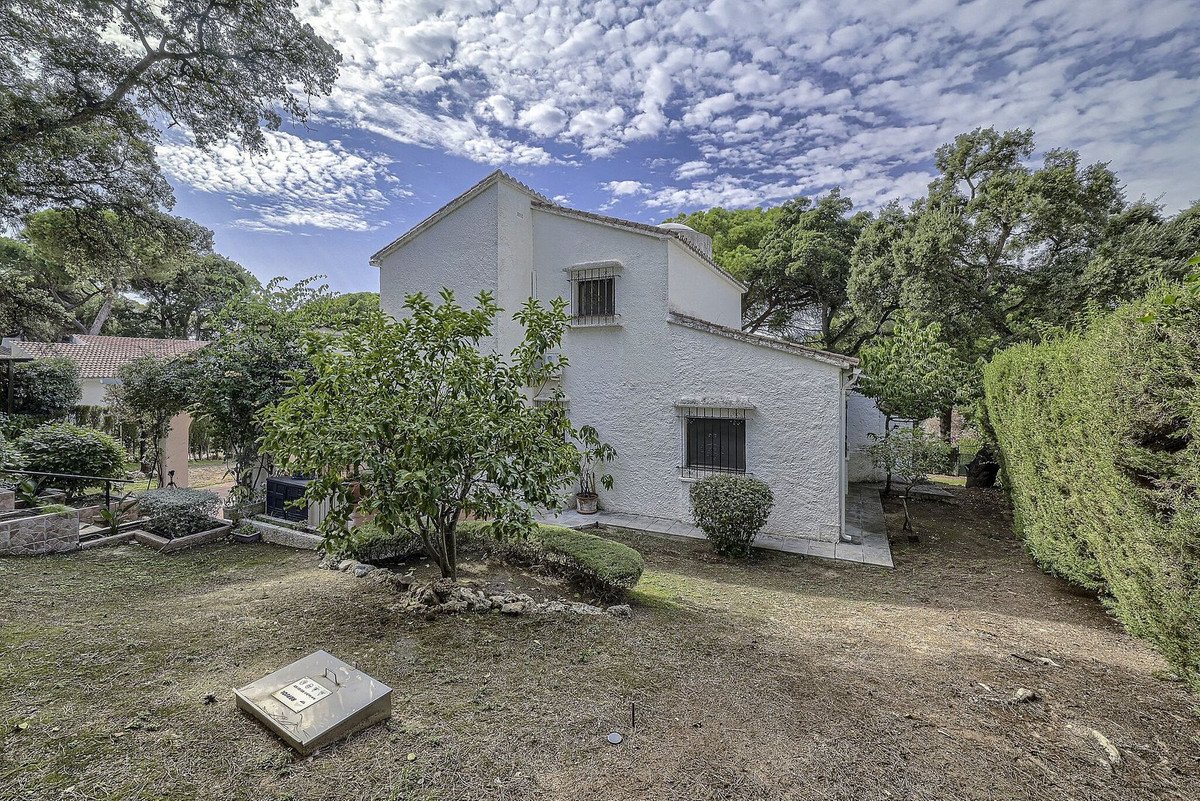 White villa with garden and outdoor space under blue sky