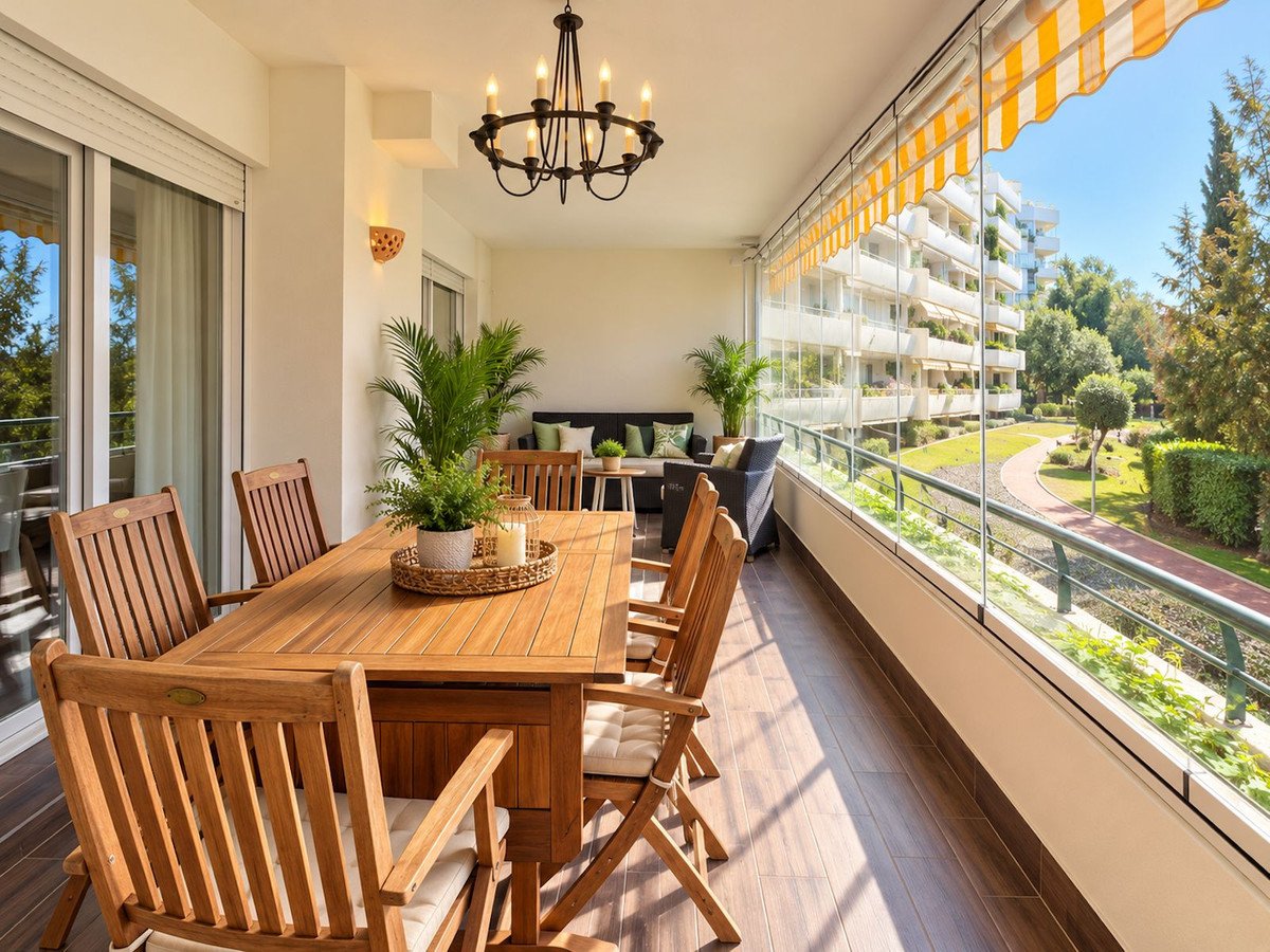 Balcony dining area with wooden table, chairs, and garden view