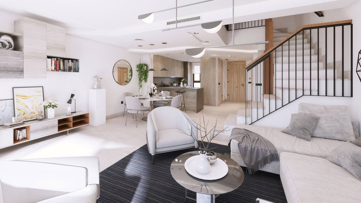 Stijlvol Almazara Views interieur met open woonkamer, eethoek en trap.