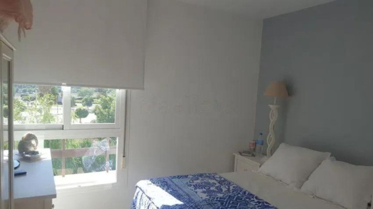 A bedroom with a bed, window, and outdoor view