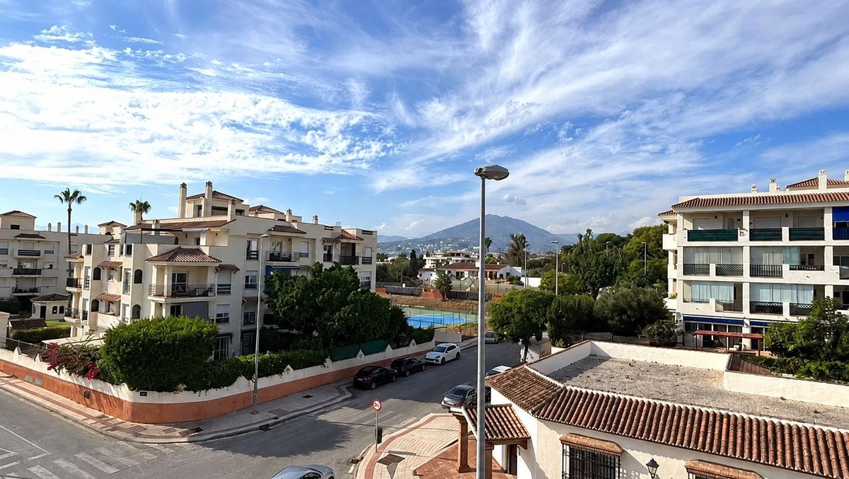 Apartment view with pool and mountain in background