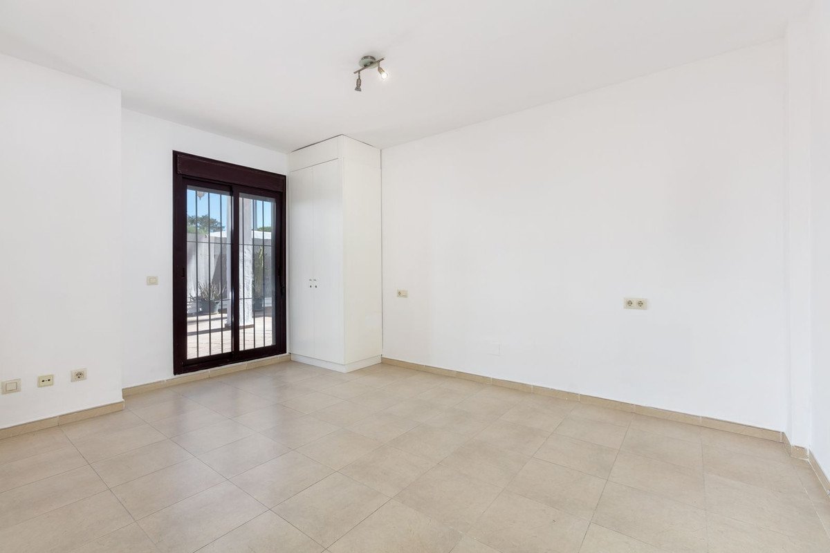 Empty living room with tiled floor and patio door leading to outdoor area