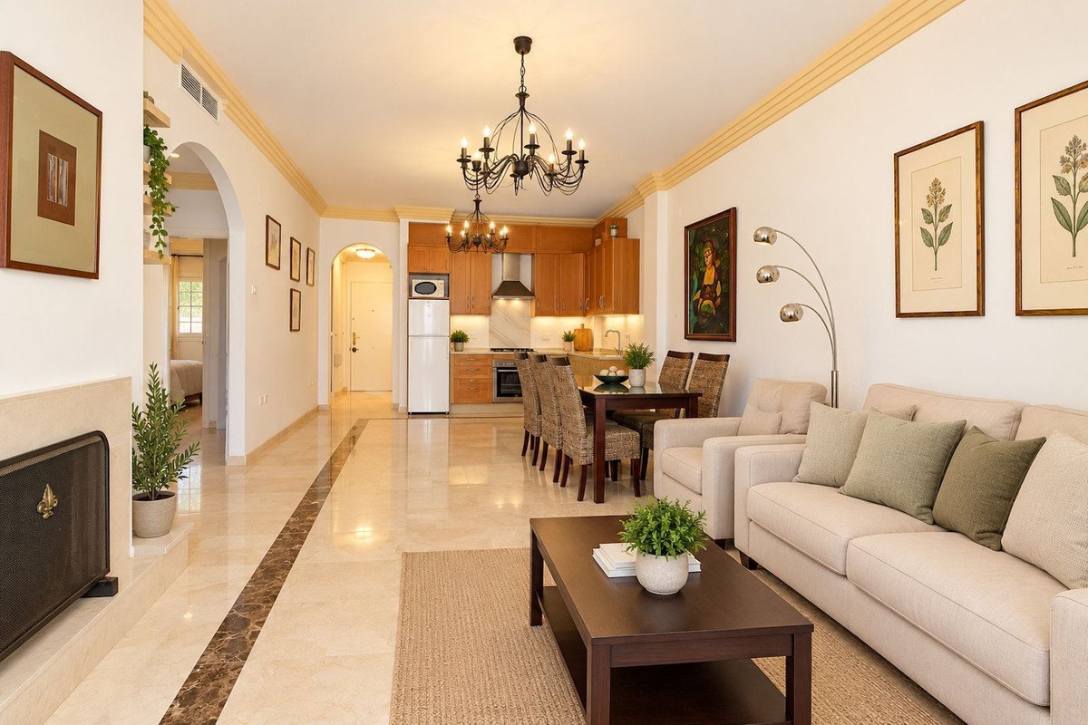 Spacious open-plan living and dining area with a modern kitchen, comfortable seating, and elegant decor.