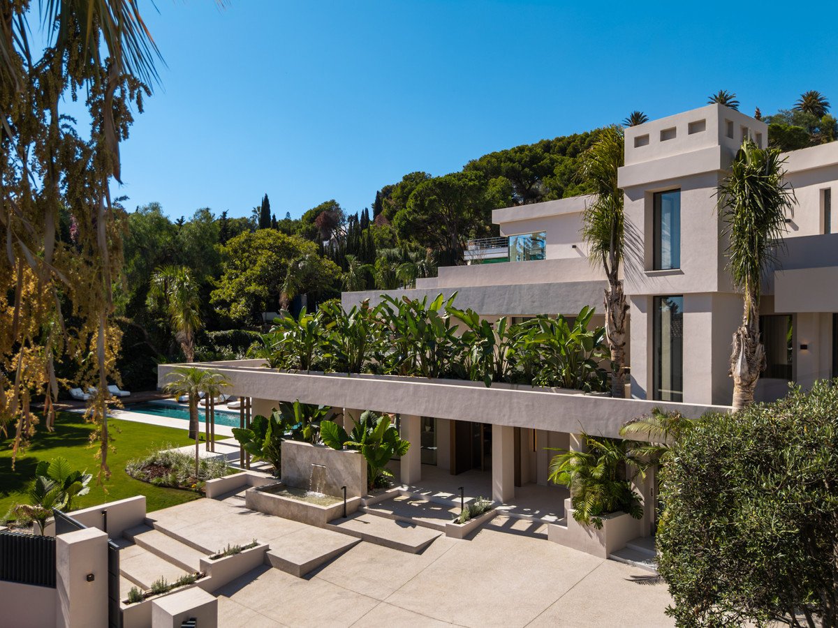 Modern villa with pool, landscaped garden, and sunny outdoor space