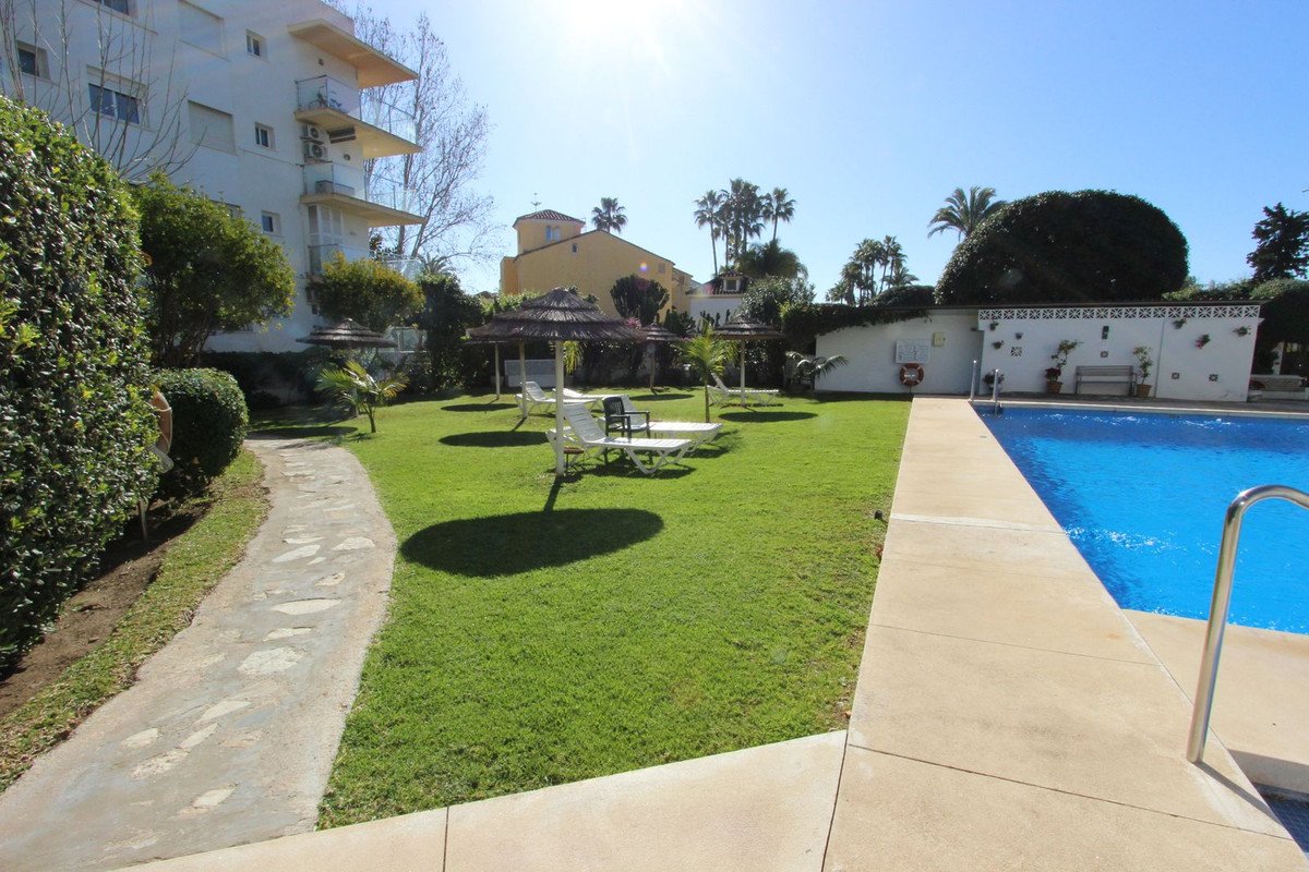 Apartment with swimming pool, garden, and outdoor seating area