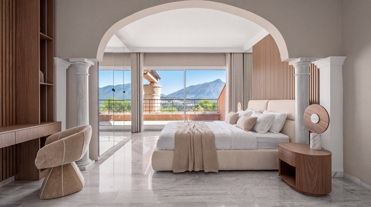 A luxurious bedroom with a large bed and stunning mountain views from the balcony visible balcony and large windows.