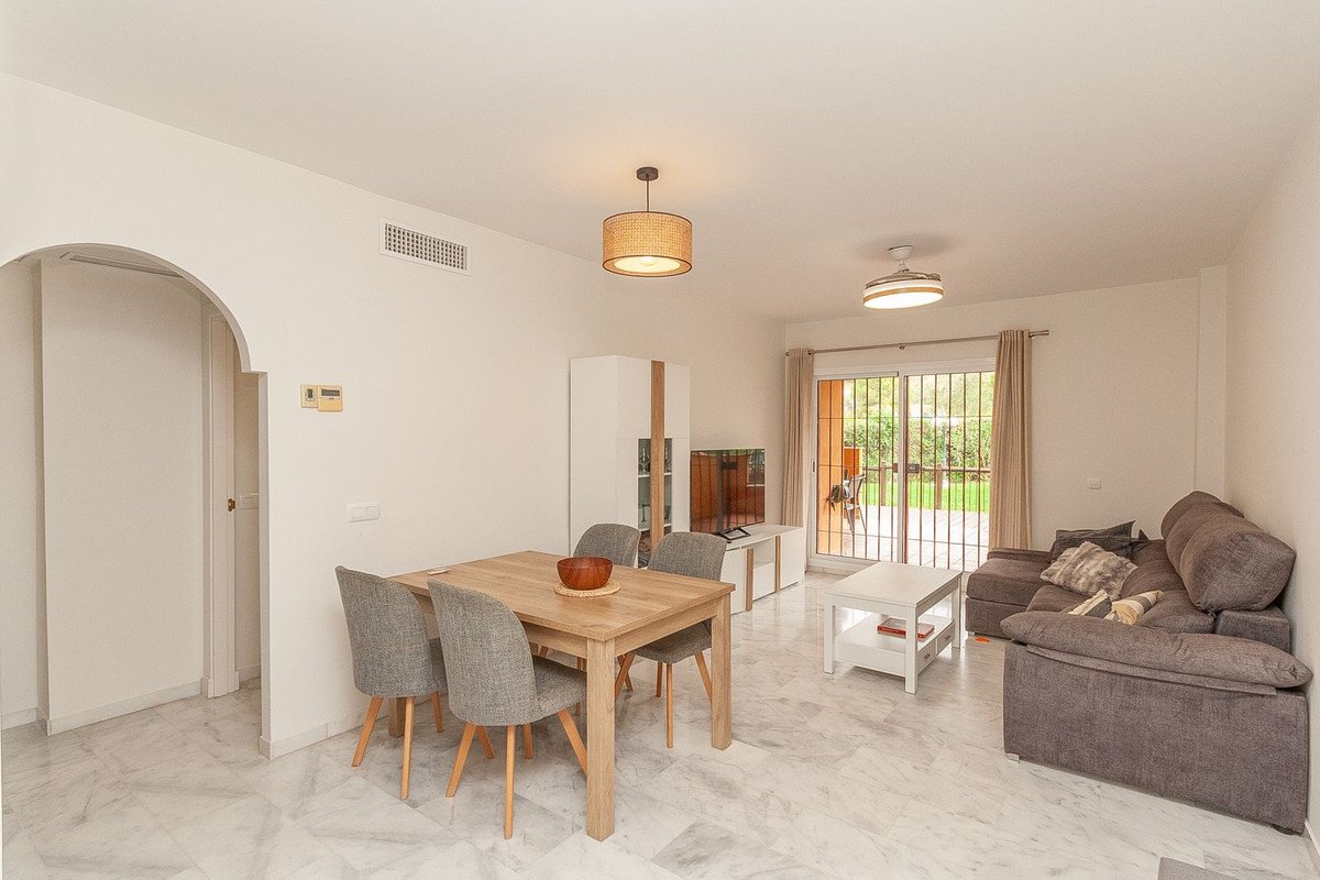 Open-plan living and dining area with patio view and comfortable seating