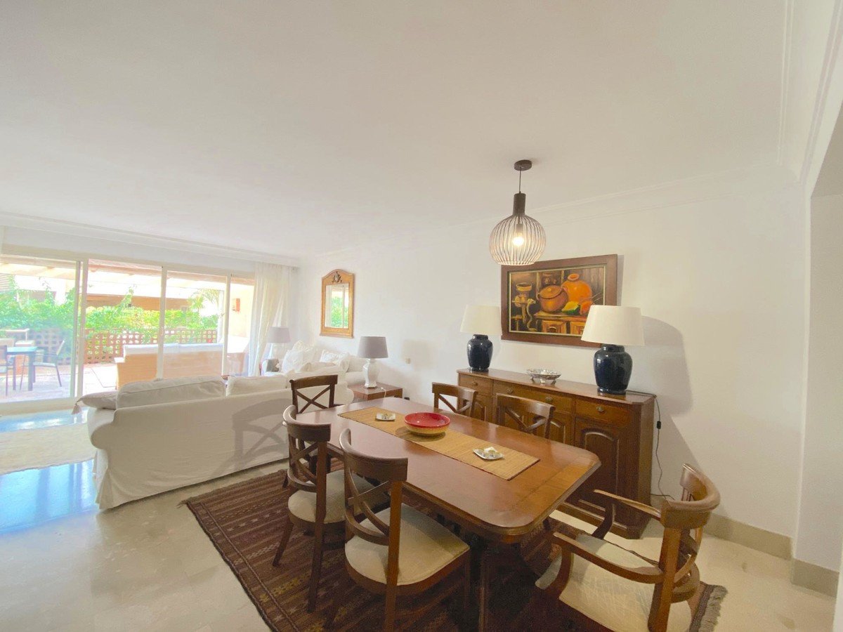 Open-plan living and dining room with sliding doors to outdoor patio