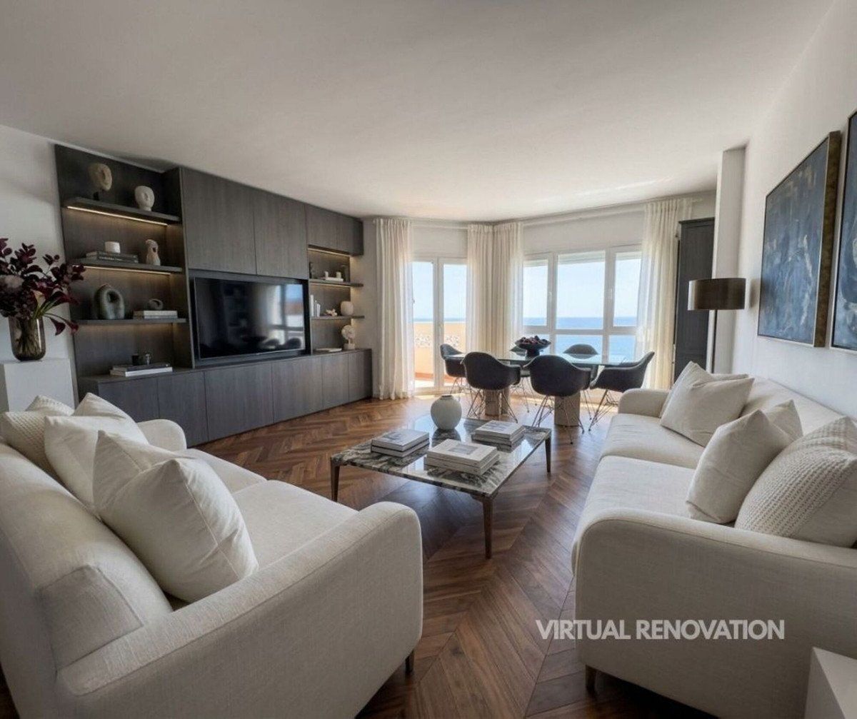 Modern living room with white sofas, herringbone floor, and sea view through large windows