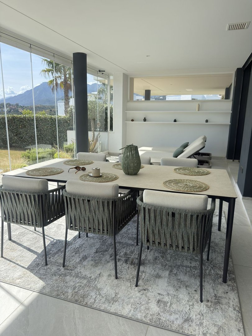Modern dining room with mountain view through large windows