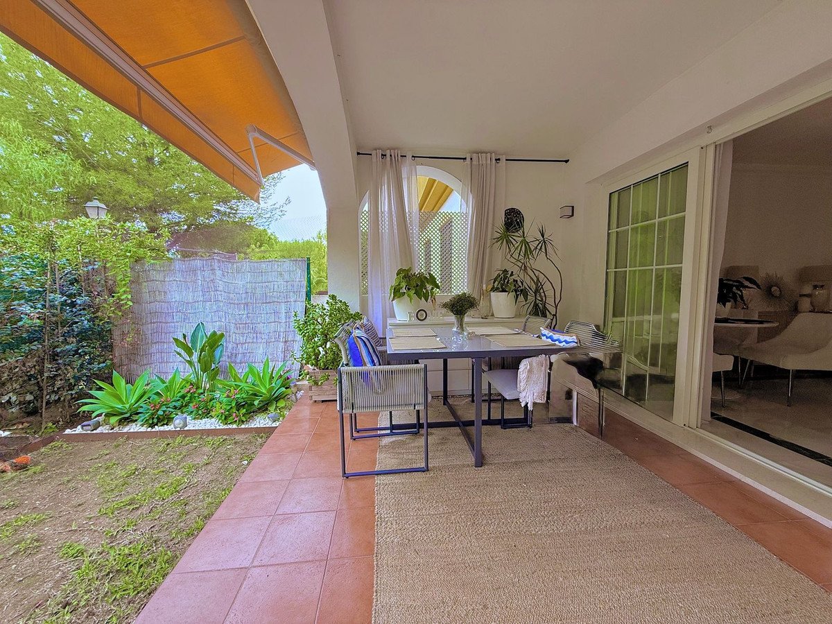 Patio dining area with garden view and indoor-outdoor sliding doors
