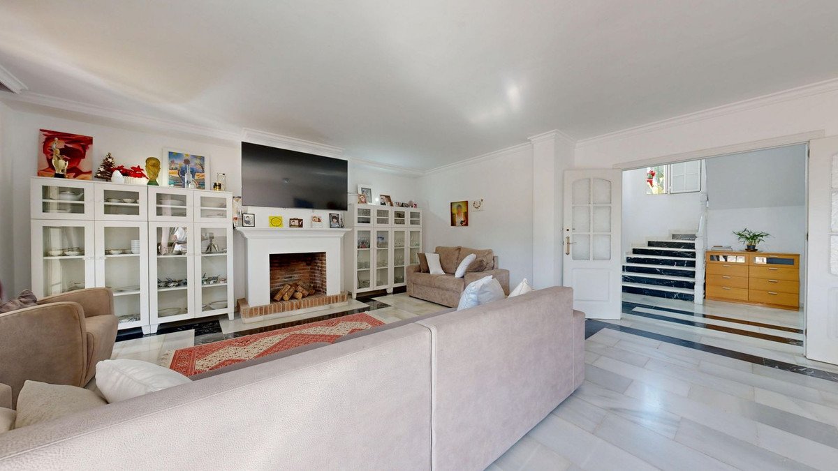 Spacious living room with fireplace, built-in shelves, and comfortable seating