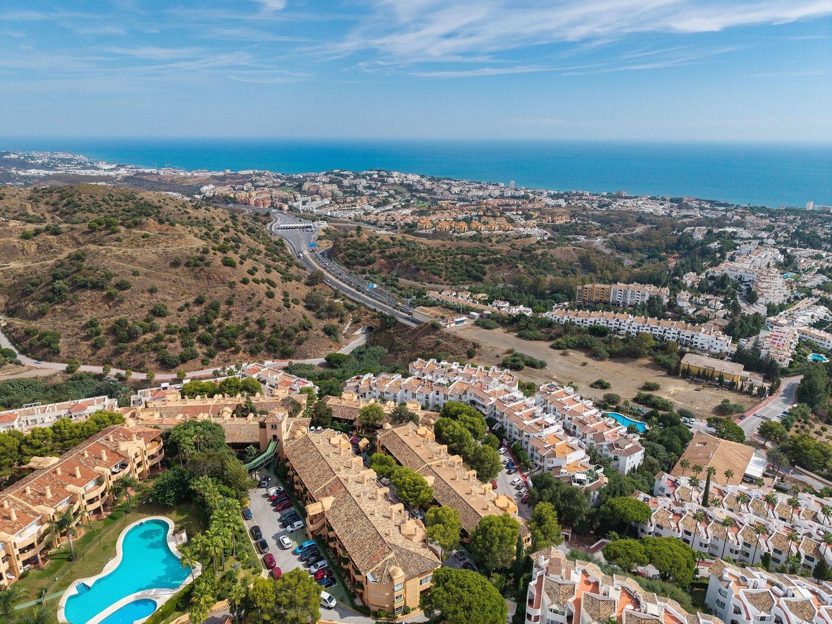 Aerial view of a residential complex with swimming pool and sea view.