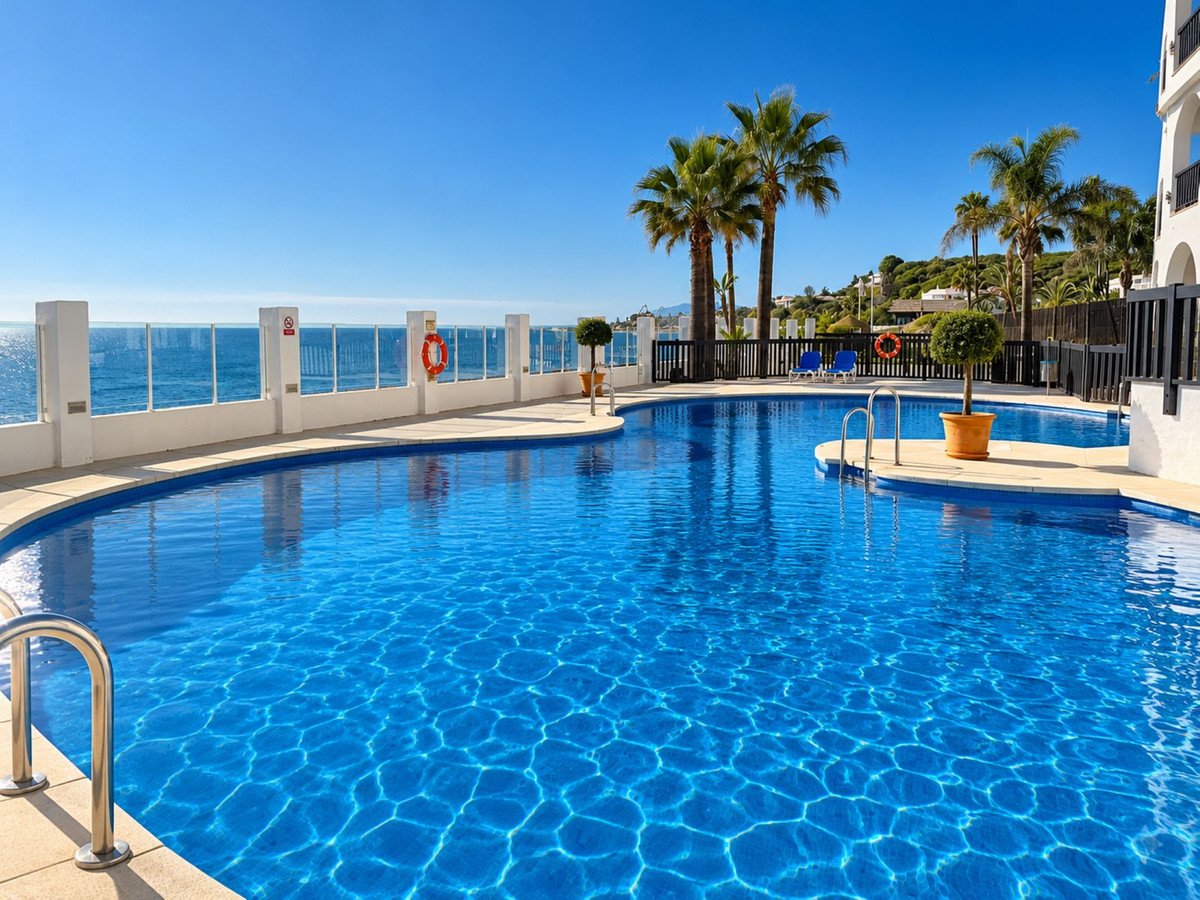 Outdoor swimming pool with clear blue water and sea view
