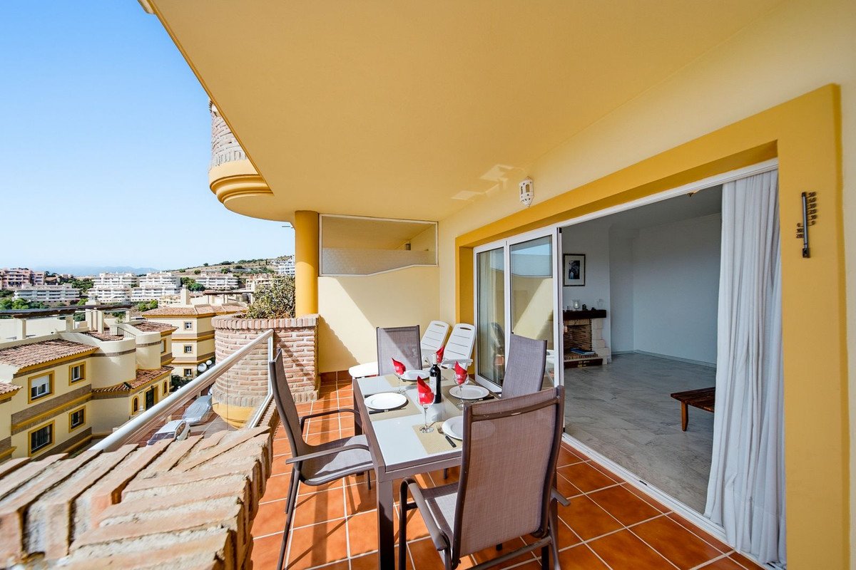 Balcony with dining table, chairs, and sea view from apartment VL672576