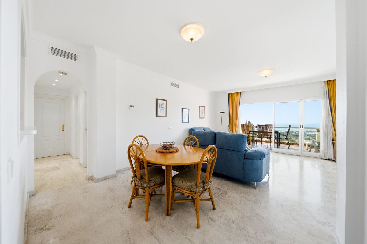 Open-plan living and dining area with sea view through large windows