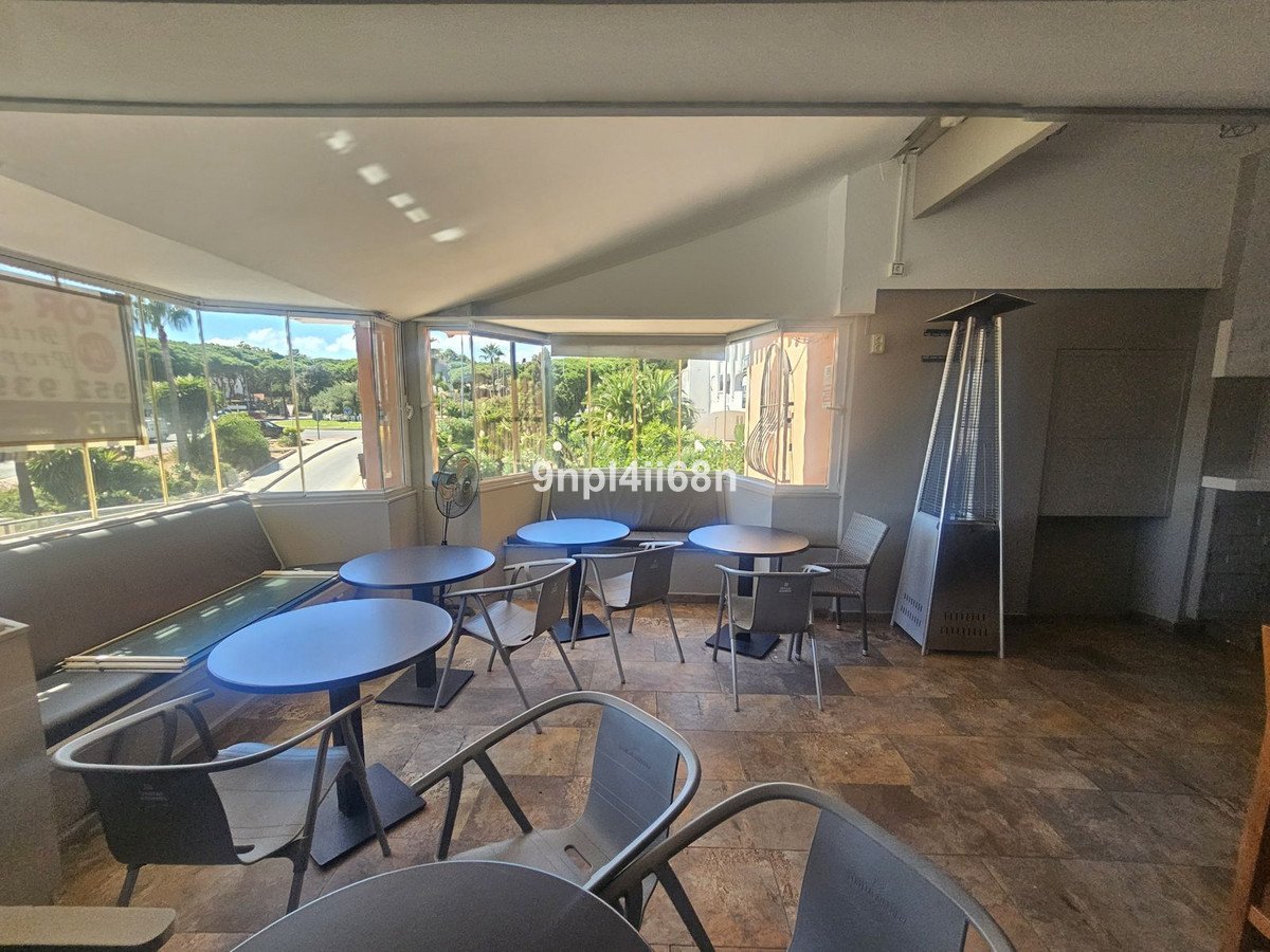 Cafe indoor seating with large windows and outdoor view