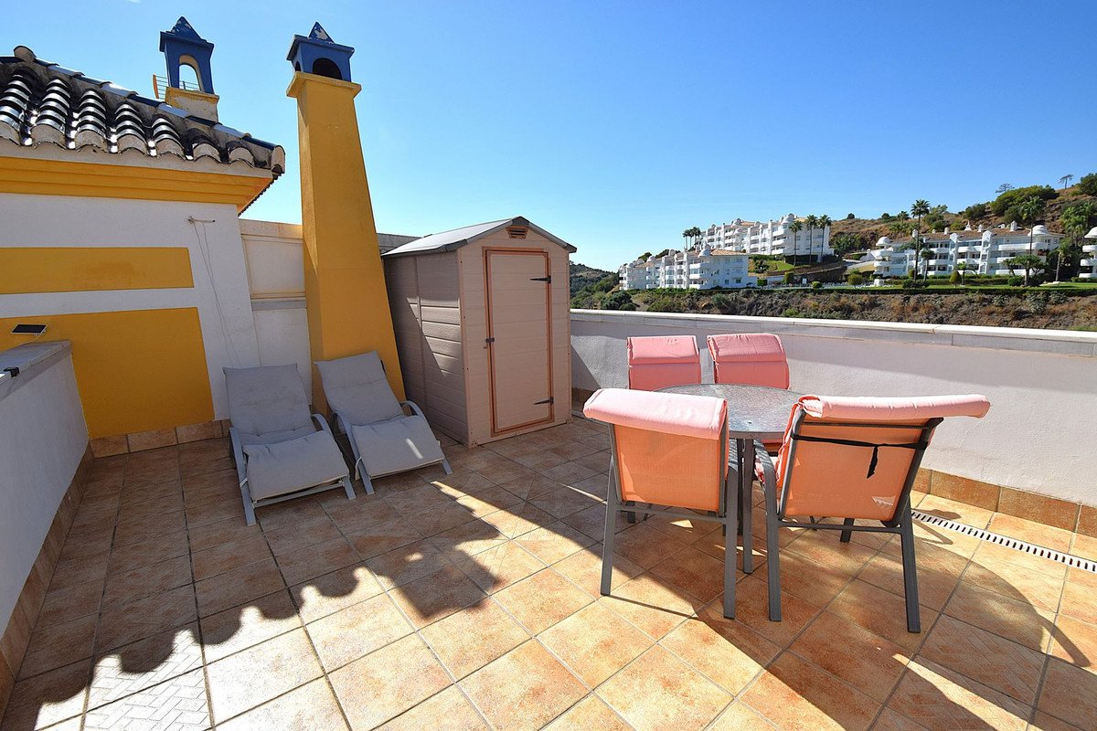 Rooftop terrace with outdoor dining set, lounge chairs, and storage shed
