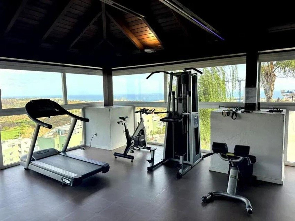 Modern gym with sea view and fitness equipment