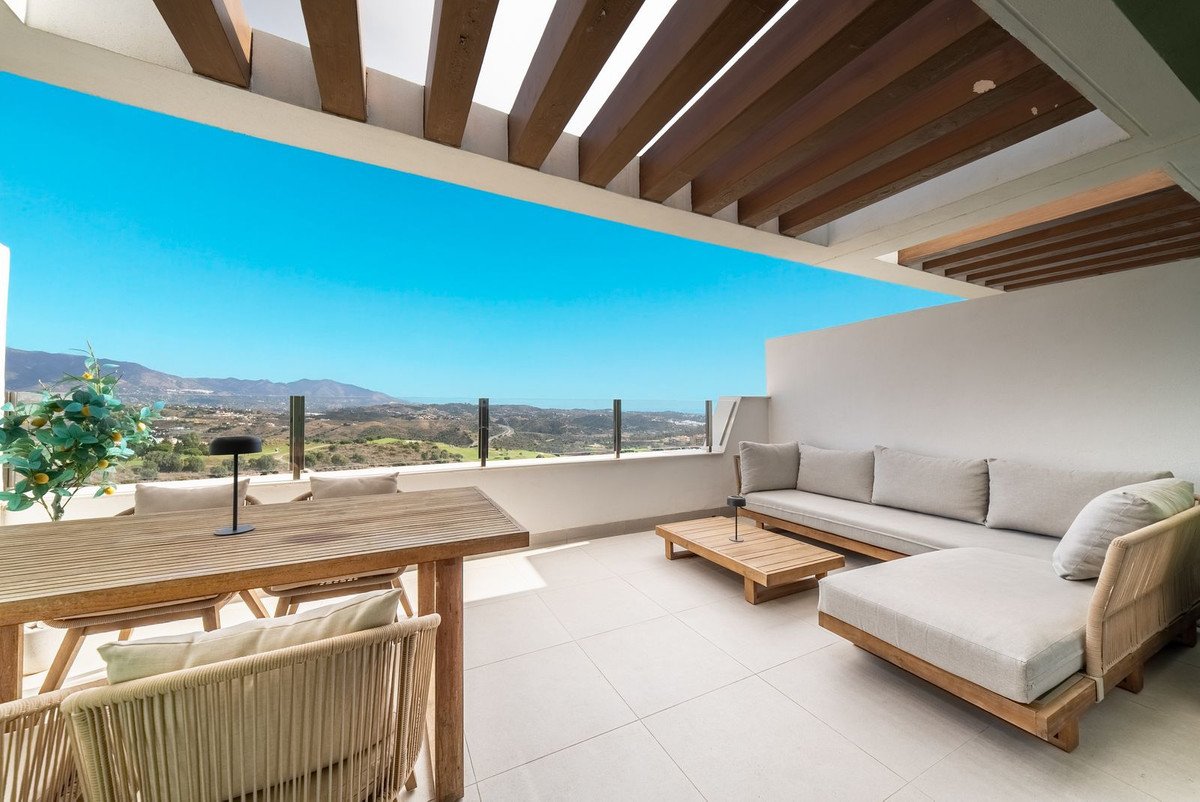 Modern rooftop terrace with lounge seating and sea view