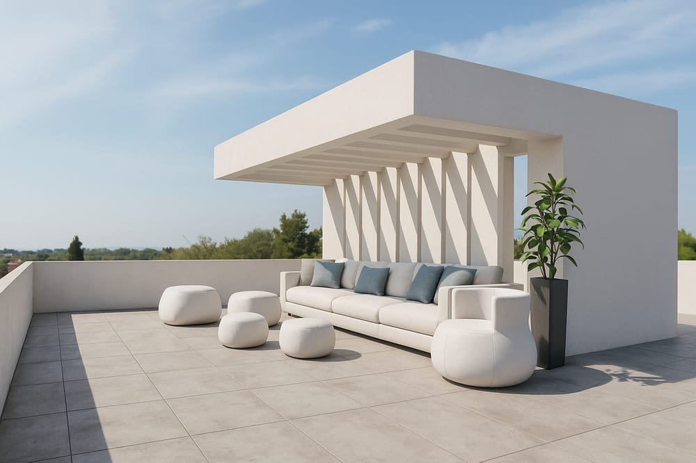 Modern rooftop lounge with a city view, white furniture, and a potted plant.