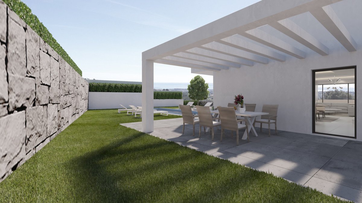 Modern outdoor dining area with a view of a pool and garden.