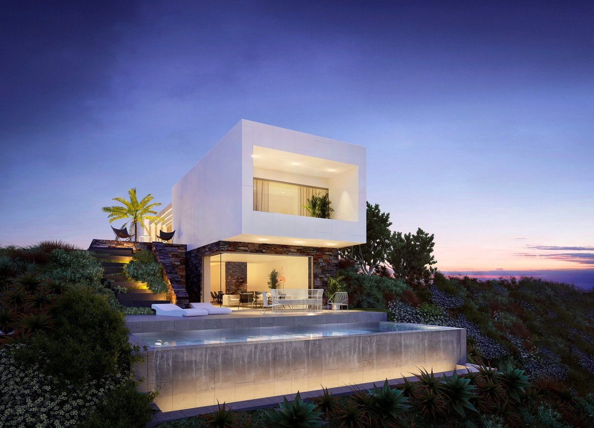 Modern white villa with pool, overlooking ocean at dusk, featuring large windows and outdoor seating.
