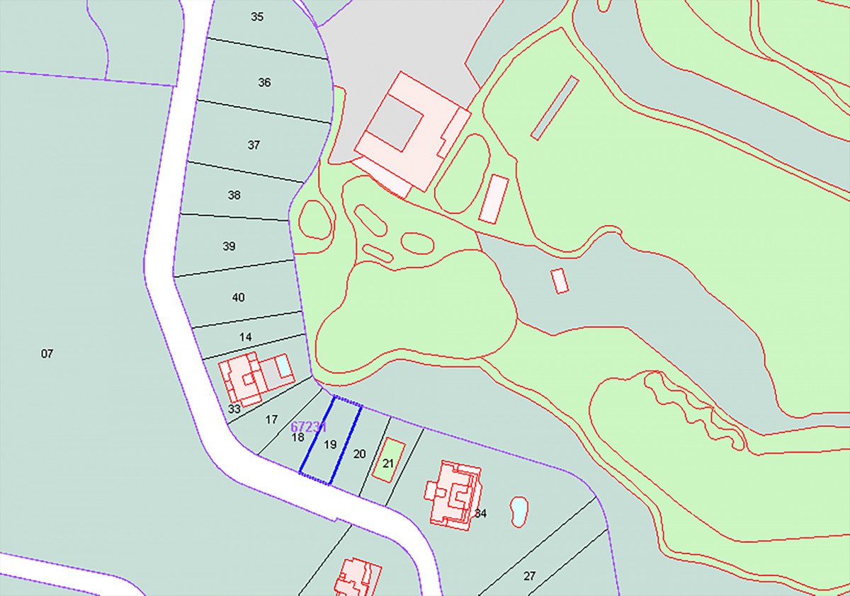 Aerial map view showing property plots with numbered sections and surrounding greenery.