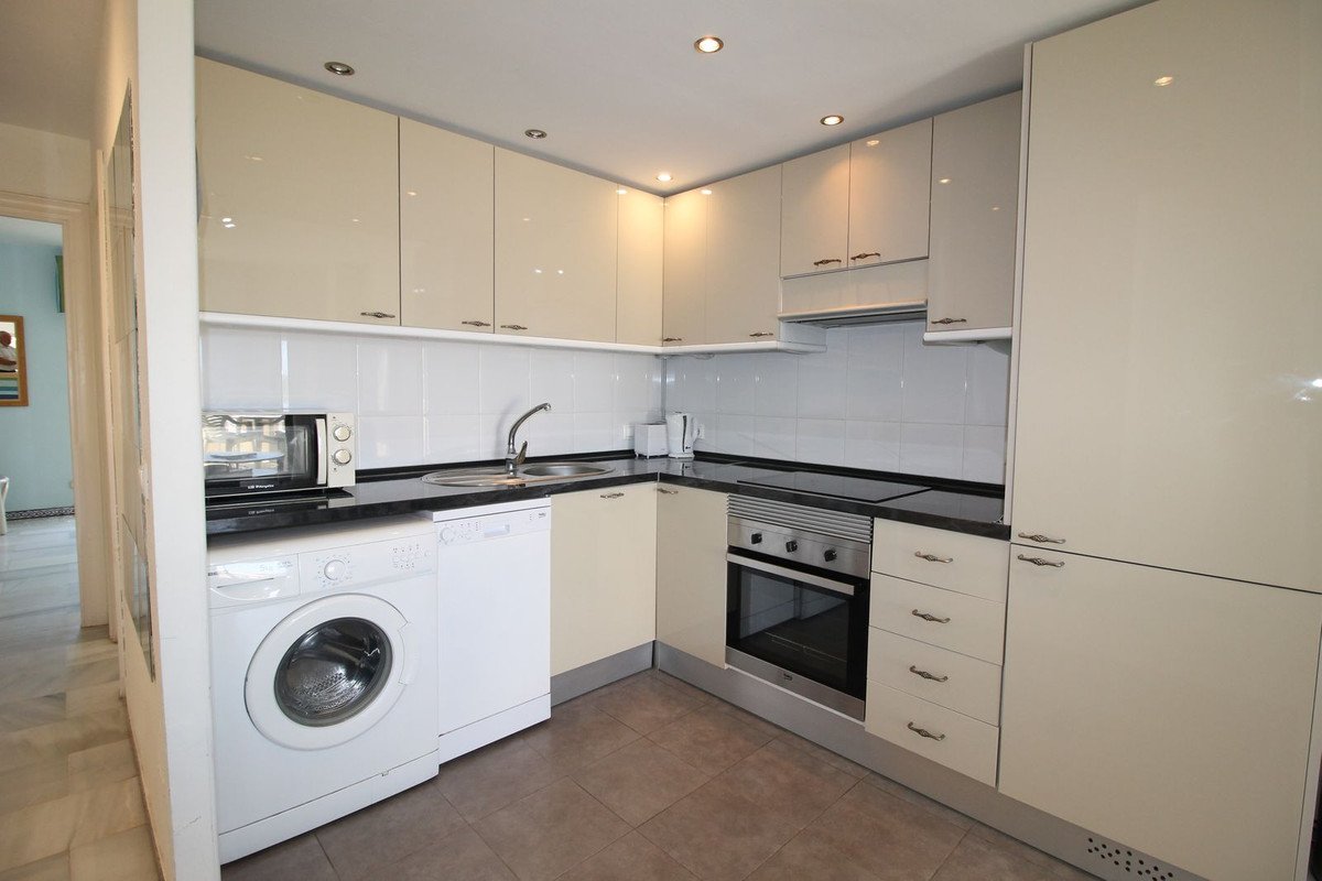 Modern kitchen with washer, dishwasher, and built-in oven