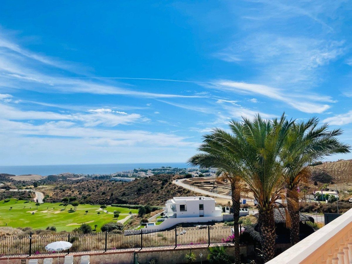 Villa with ocean and golf course views, palm trees, and clear blue sky