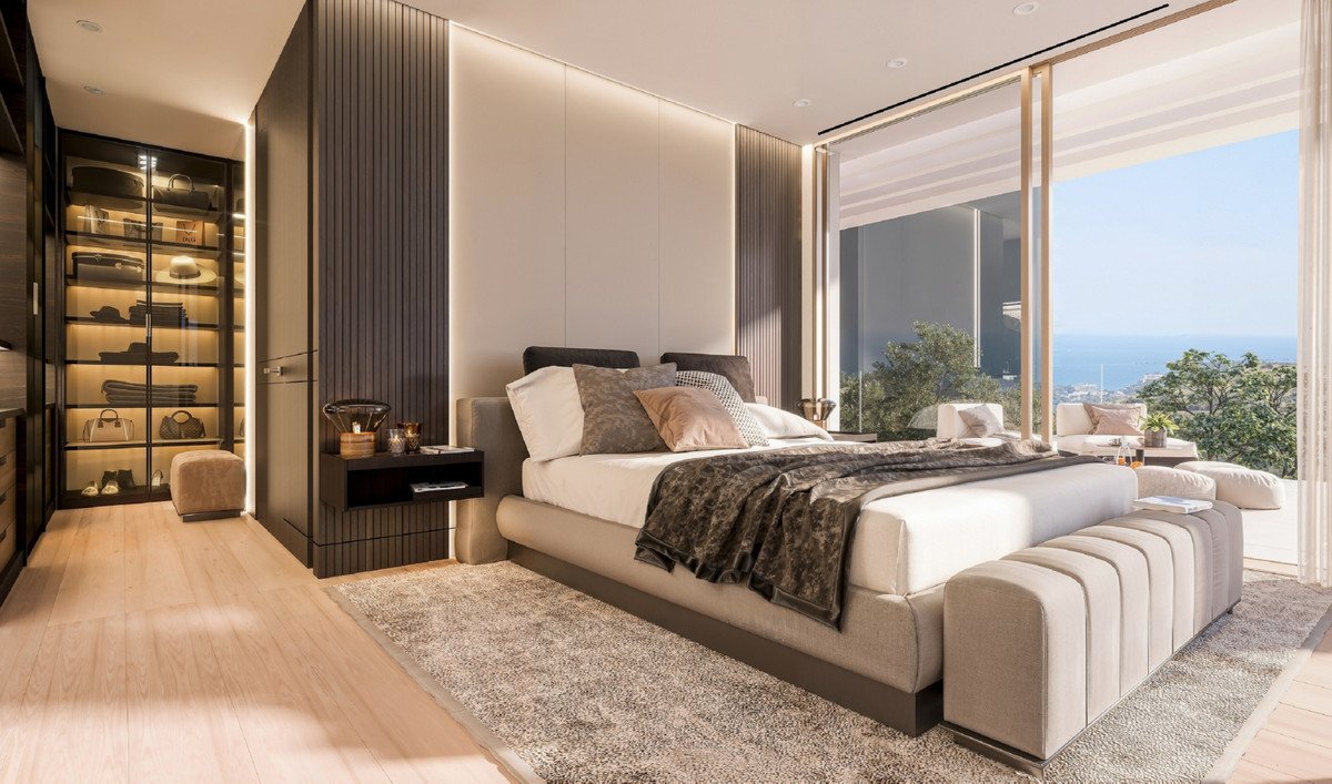 Luxurious bedroom with a king-size bed, walk-in closet, and stunning ocean view from the balcony.