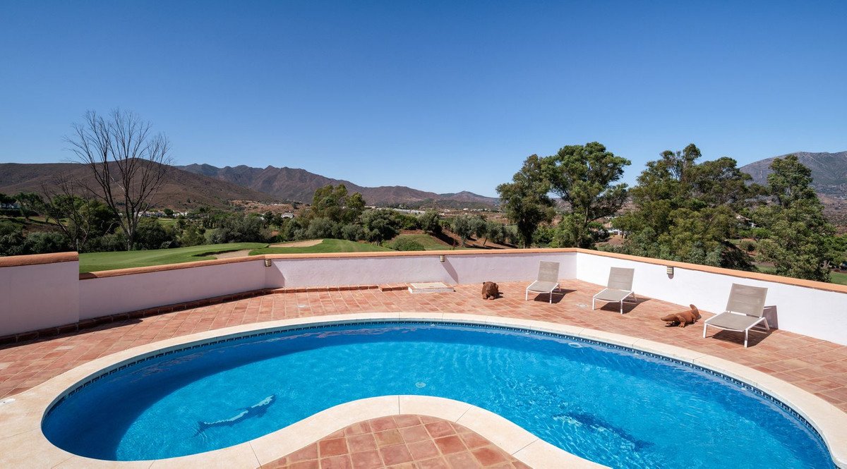 Outdoor swimming pool with mountain view and lounge chairs