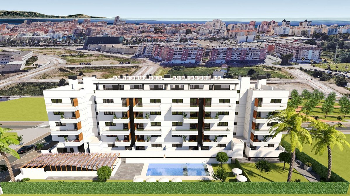Modern white apartment building with balconies, swimming pool, palm trees, and city view.
