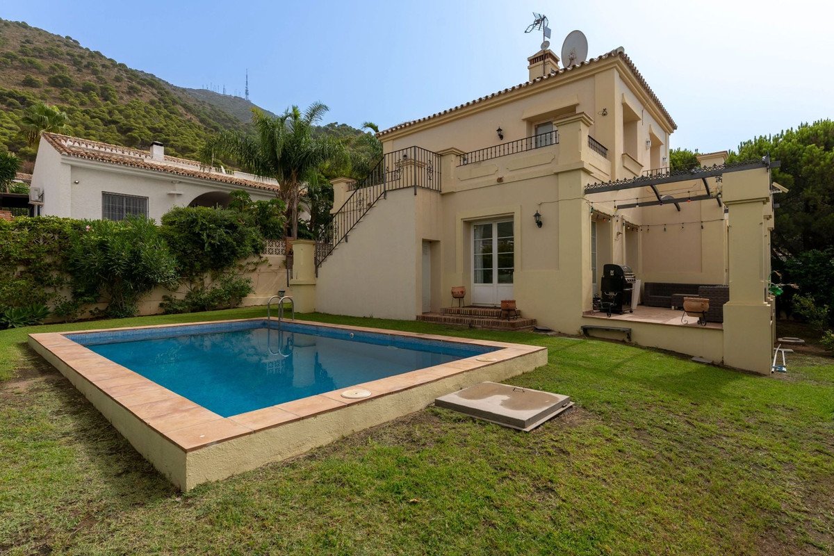 Villa with private pool, garden, and mountain views, featuring a patio and outdoor kitchen.