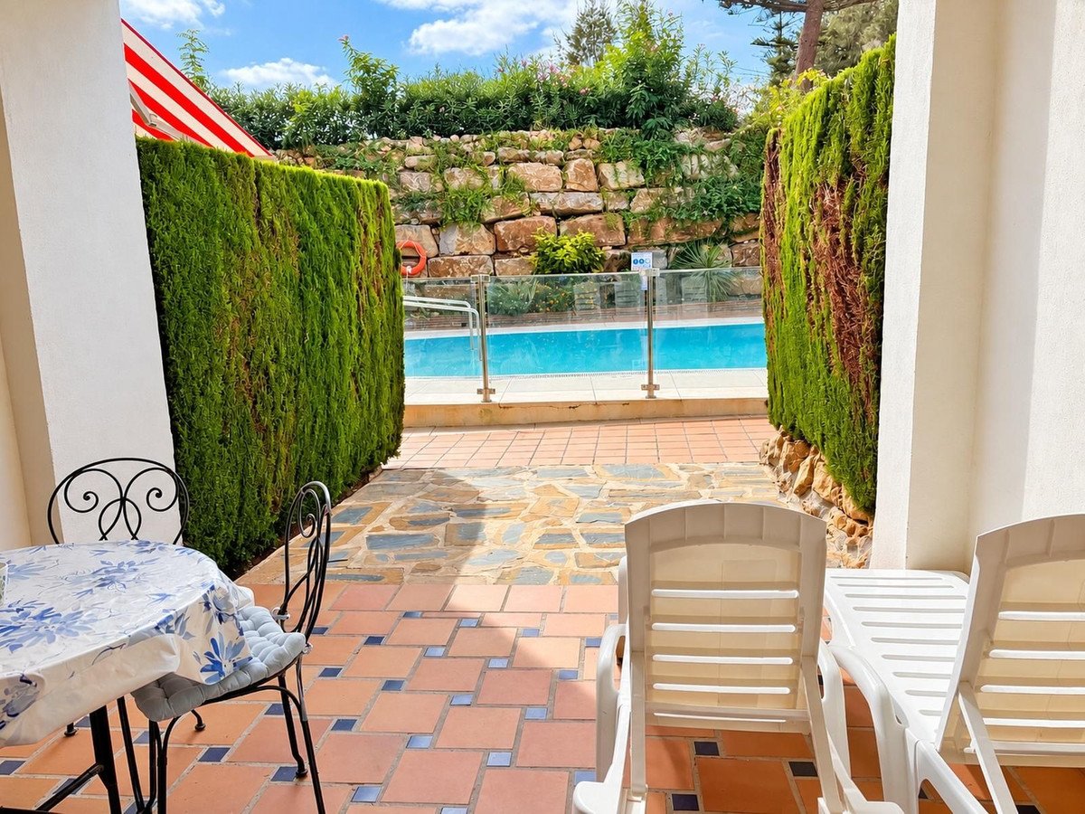 Patio with outdoor seating and view of a swimming pool