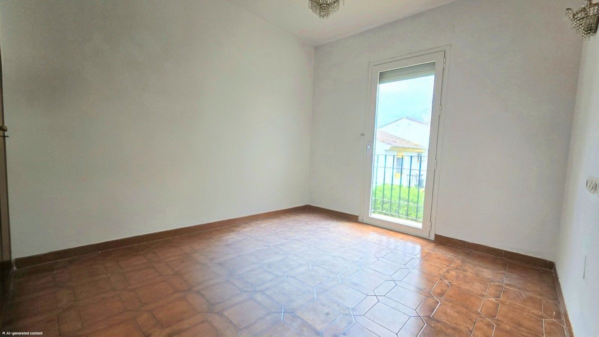 Empty room with tiled floor and garden view through glass door